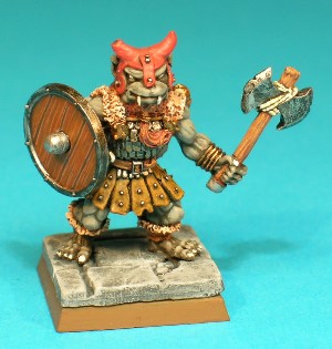 Pose 1, variant B. This variant wears a studded leather hat with horn-like protrusions and short earflaps and nasal, and his axe has a notched double blade secured by string. He has a dog-like face with a short muzzle, and a closed mouth with upper fangs protruding. he is looking forwards, and has no earrings.